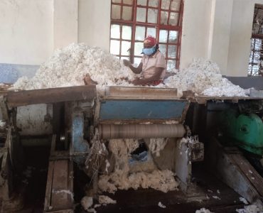 A-woman-working-at-the-Kitui-Cotton-Ginnery--scaled