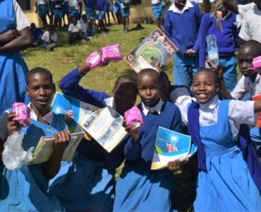 School-girls-from-Kugisingisi-primary-school-celebrating-having-successfully-completed-menstrual-health-sanitation-learning-session-696x464